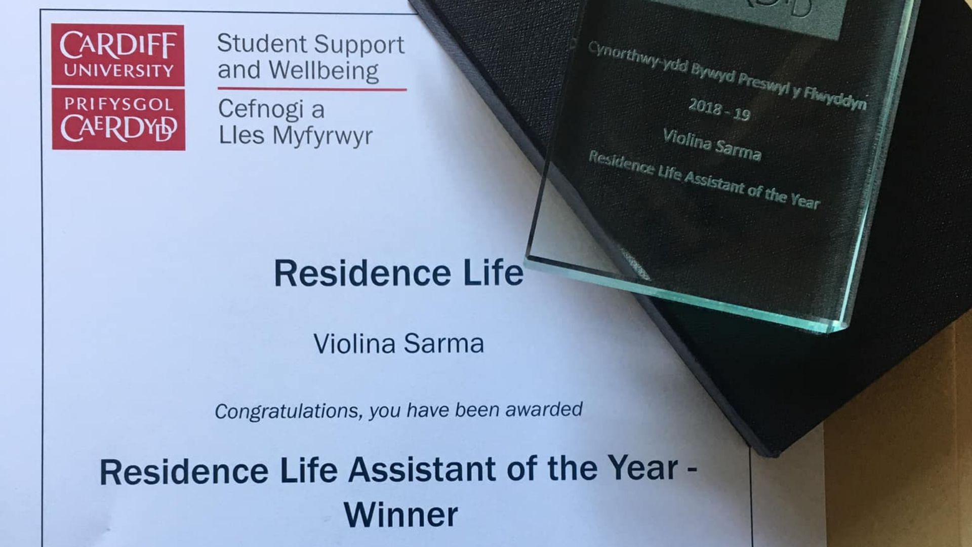 Certificate and trophy on table