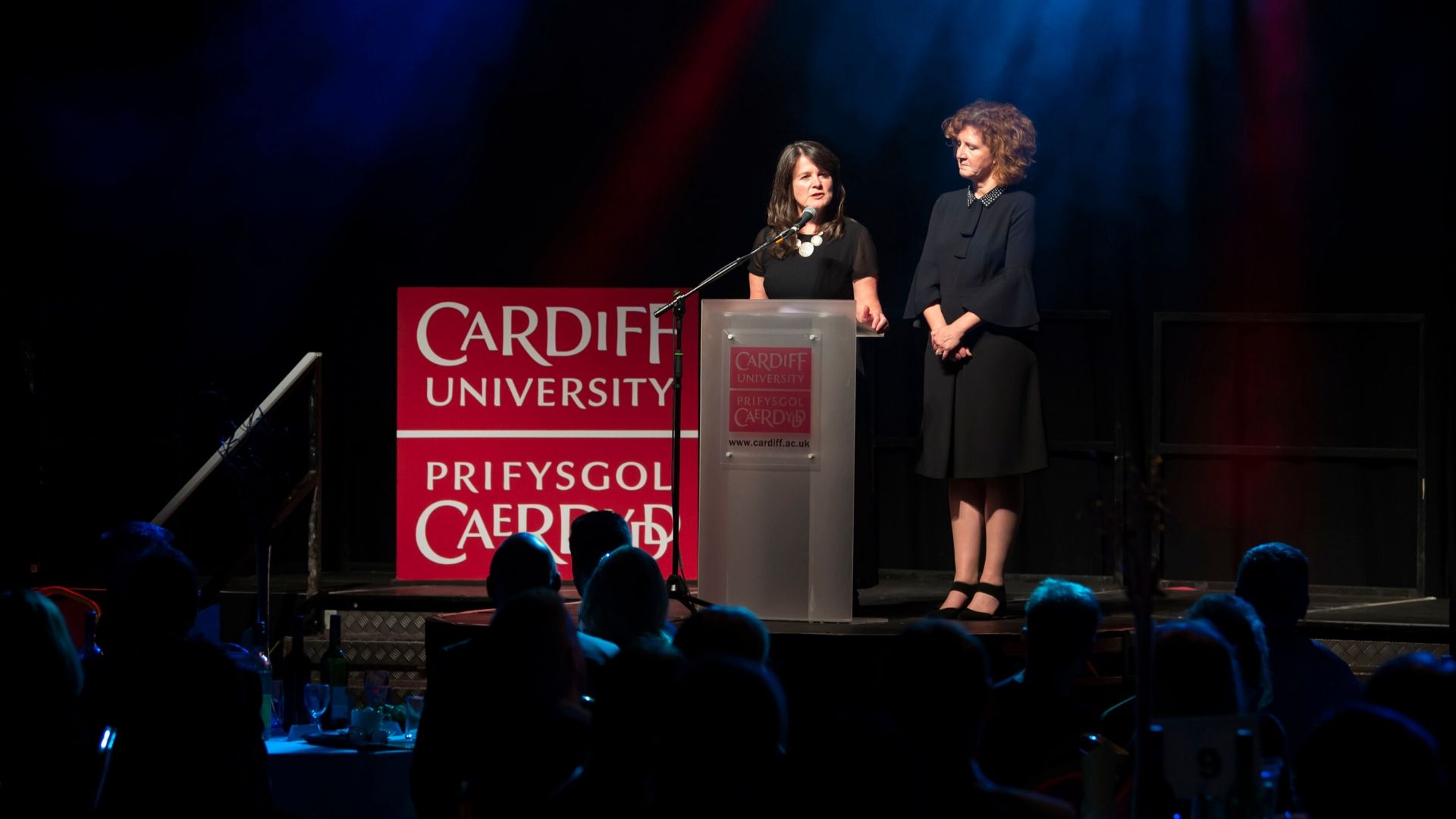 Two women presenting award ceremony