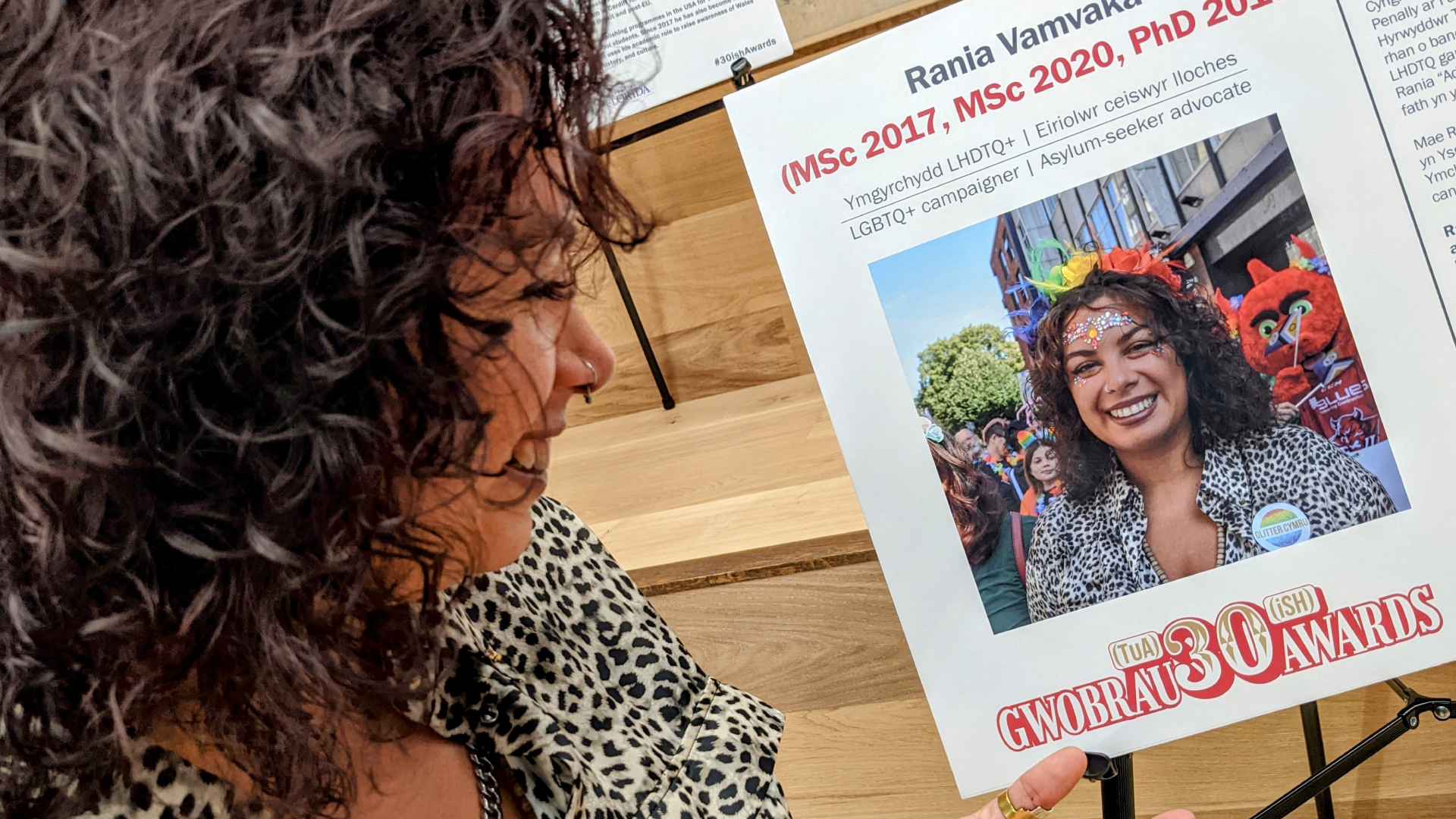 A woman looks at a certificate for an award she won.