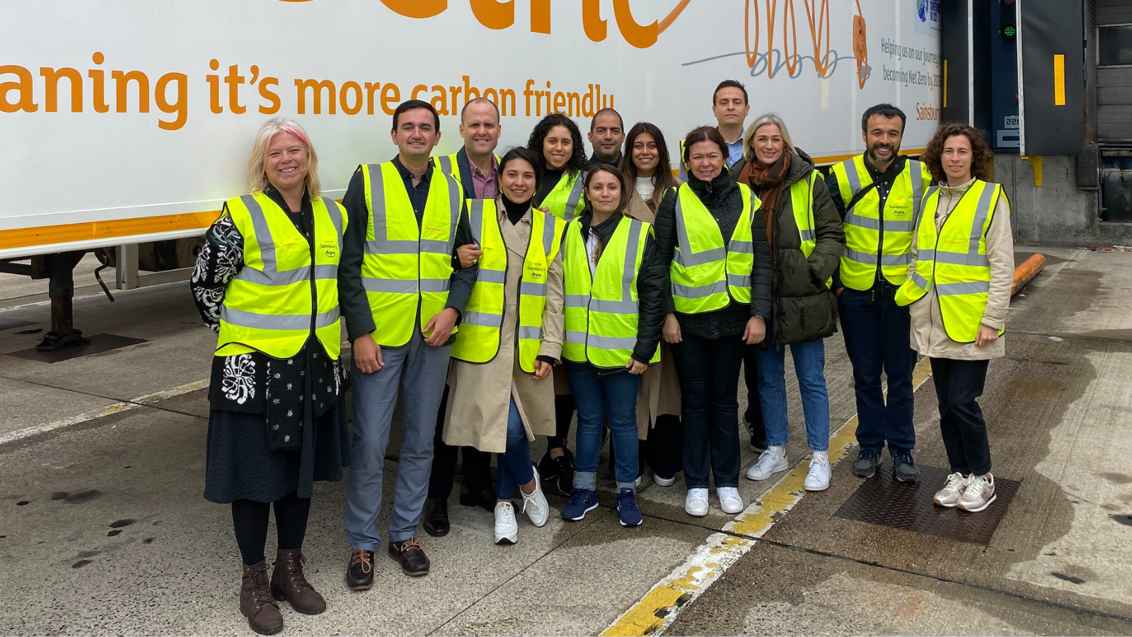 A group of people outside wearing hi-vis vests 