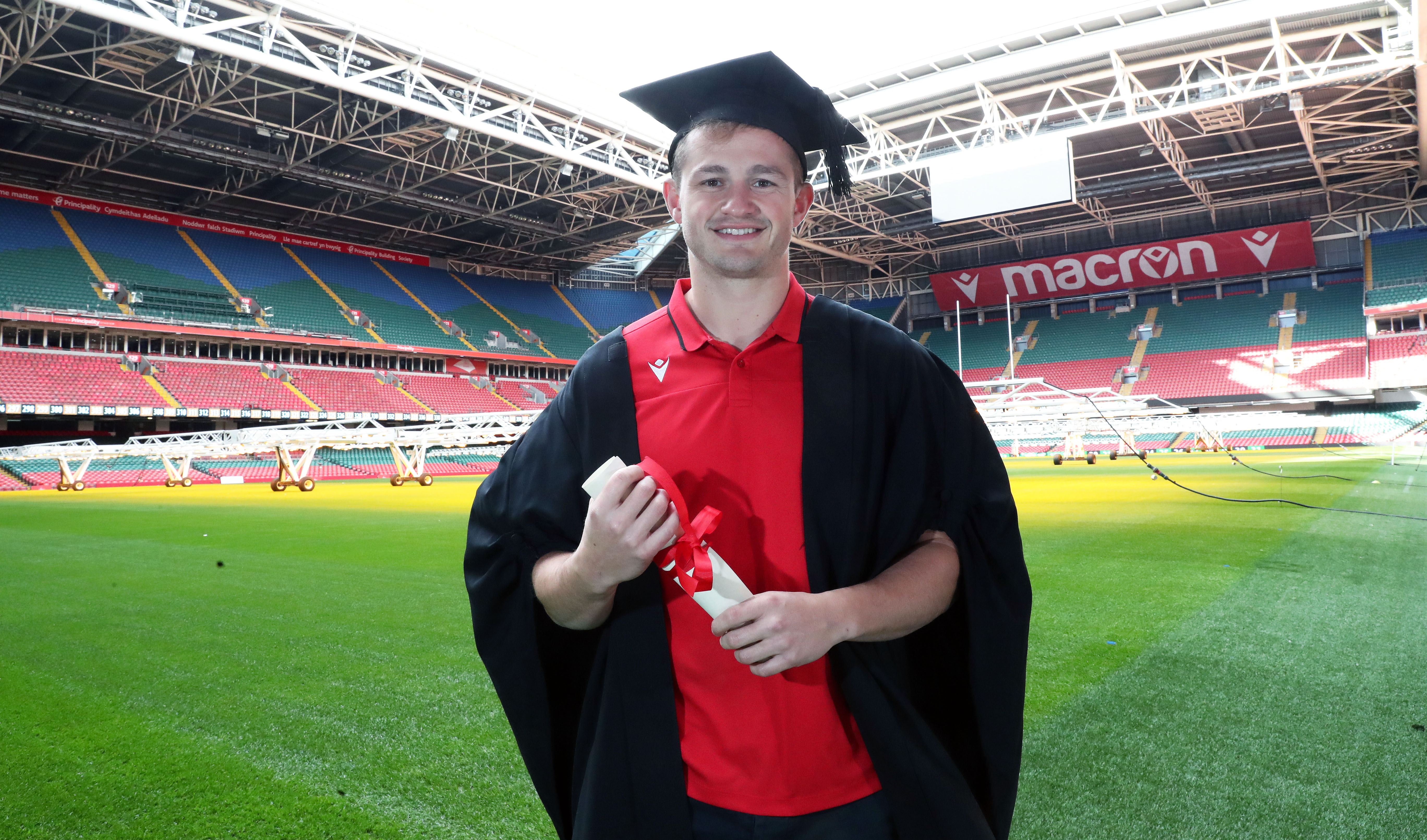 Hallam Amos wearing graduation gown in Principality Stadium