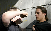 A man threatening to hit another man