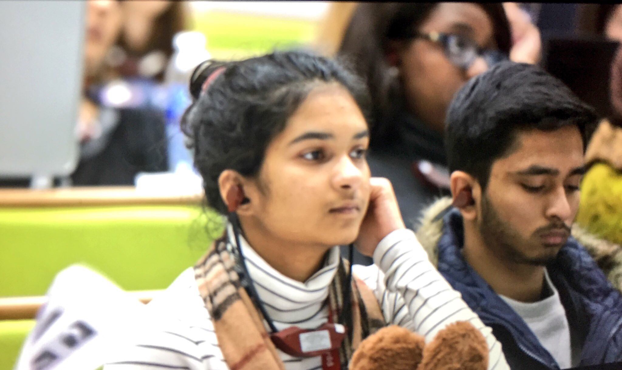 Two students listening to translation of Welsh language lecture