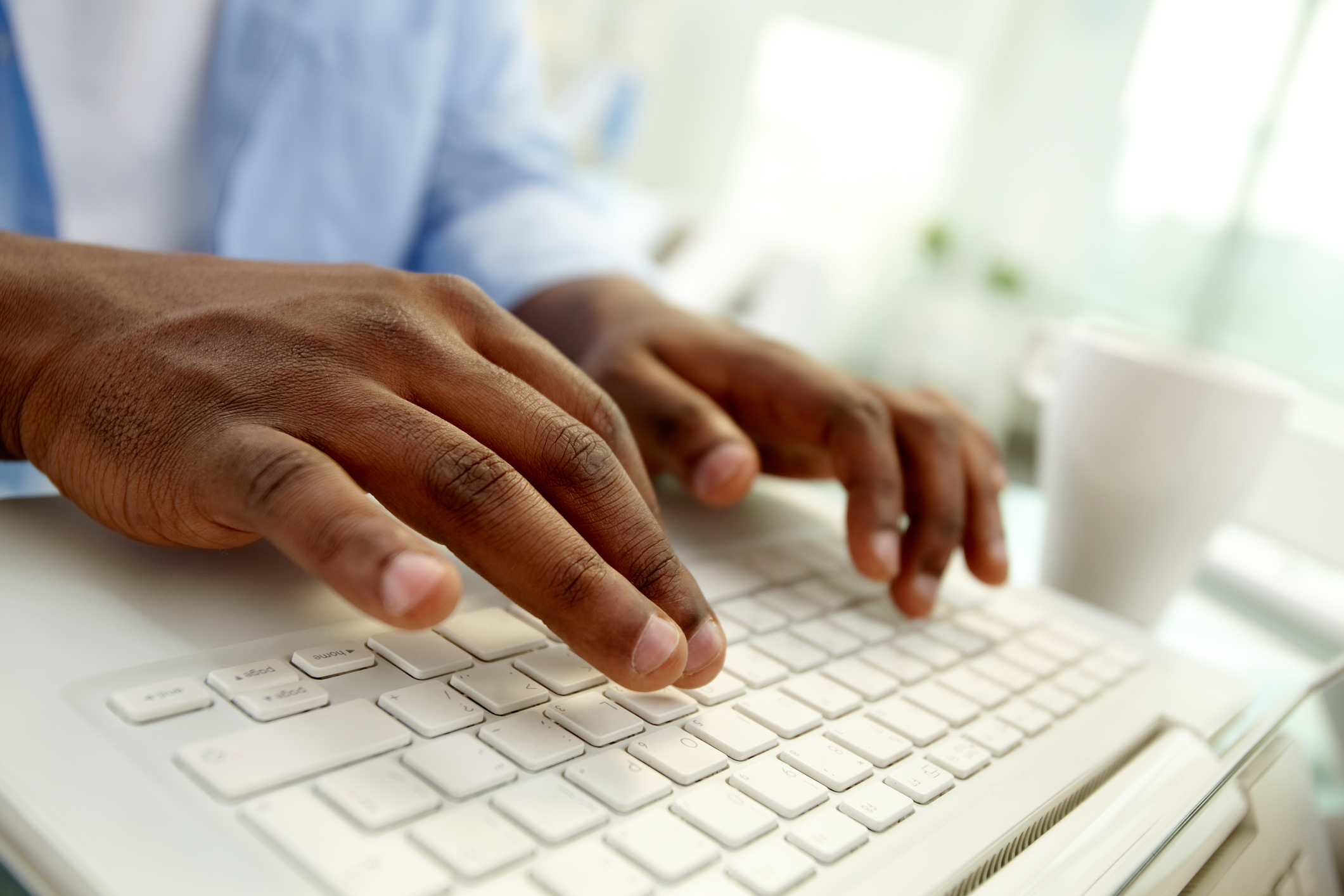 Hands typing on a keyboard