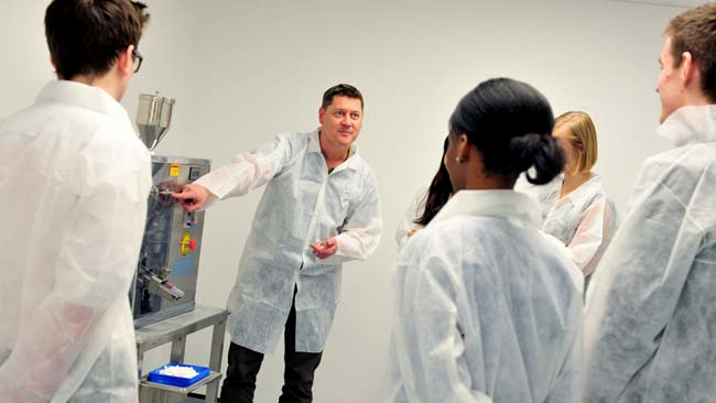 Students being taught by a researcher.