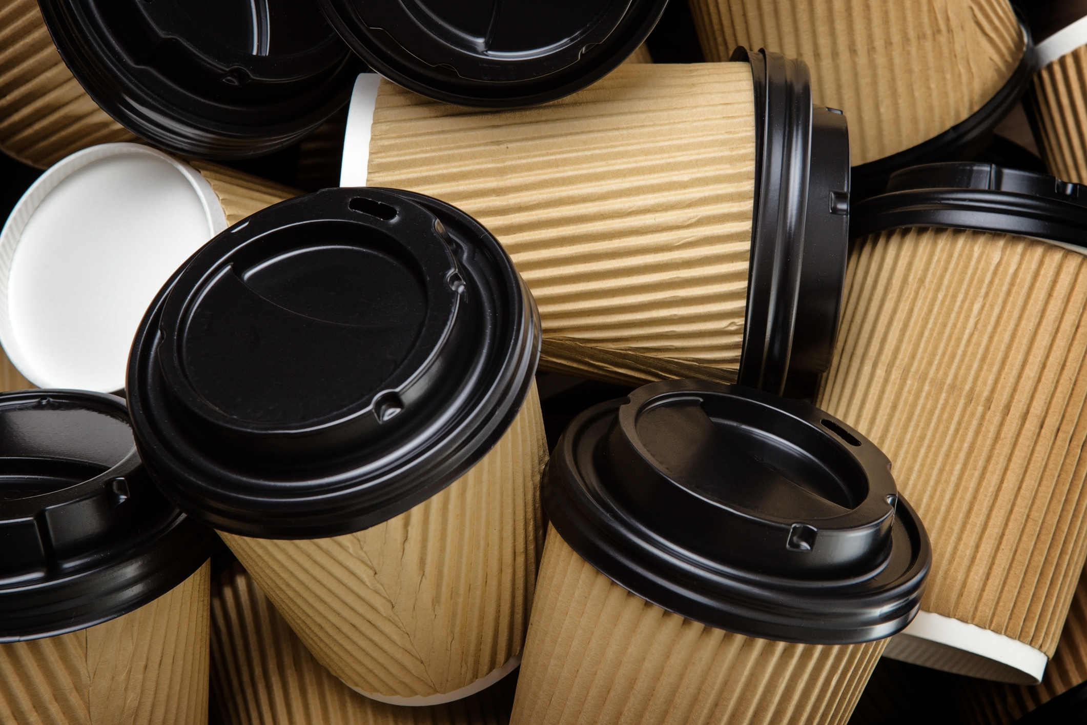 A pile of disposable coffee cups