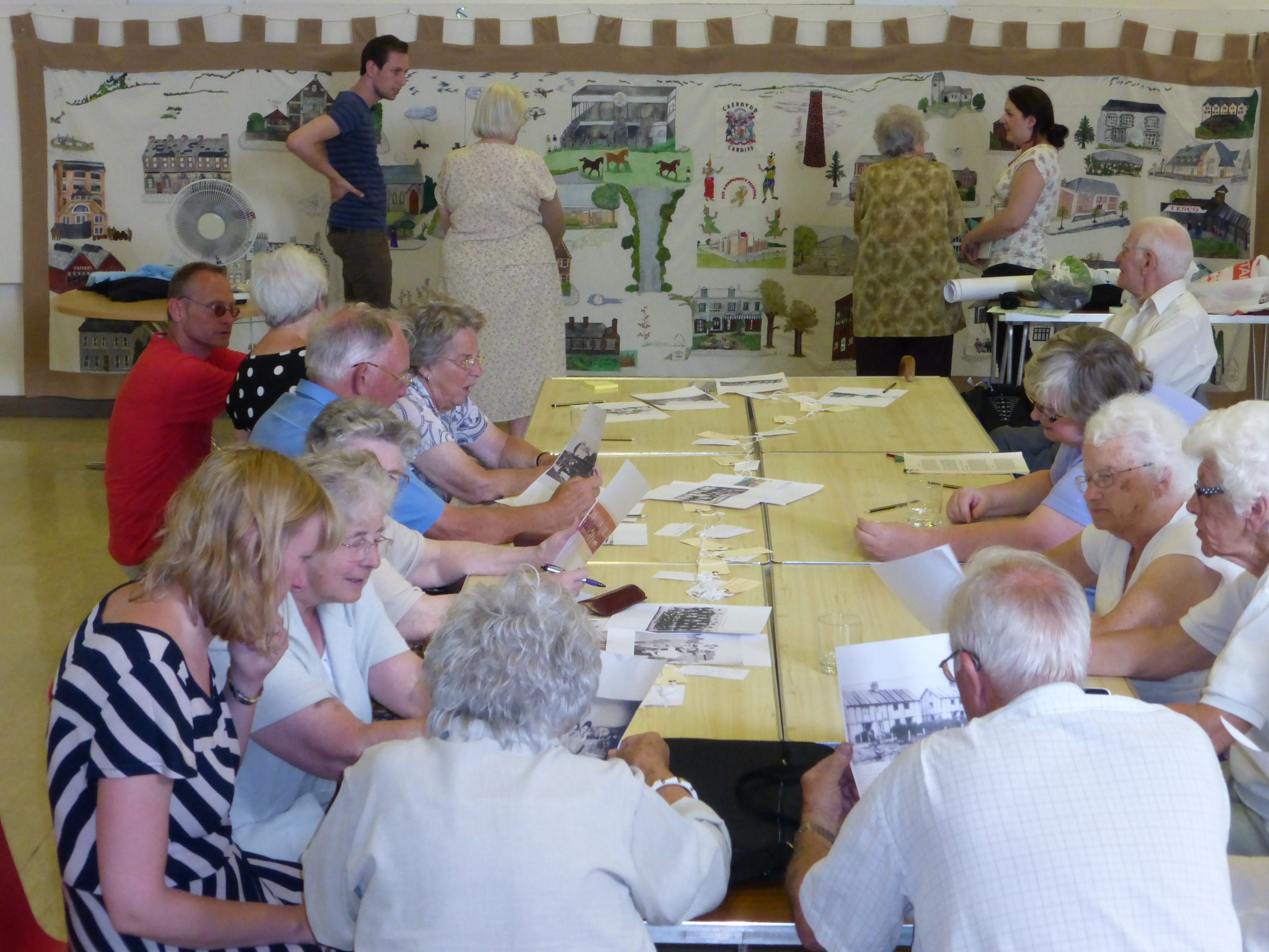 Elderly people sat around table