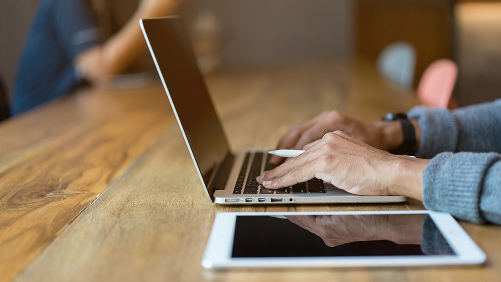 Student with laptop on table