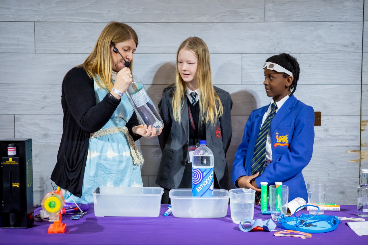 Wendy Sadler presenting her XX factor show about unsung female heroes of science to school students.