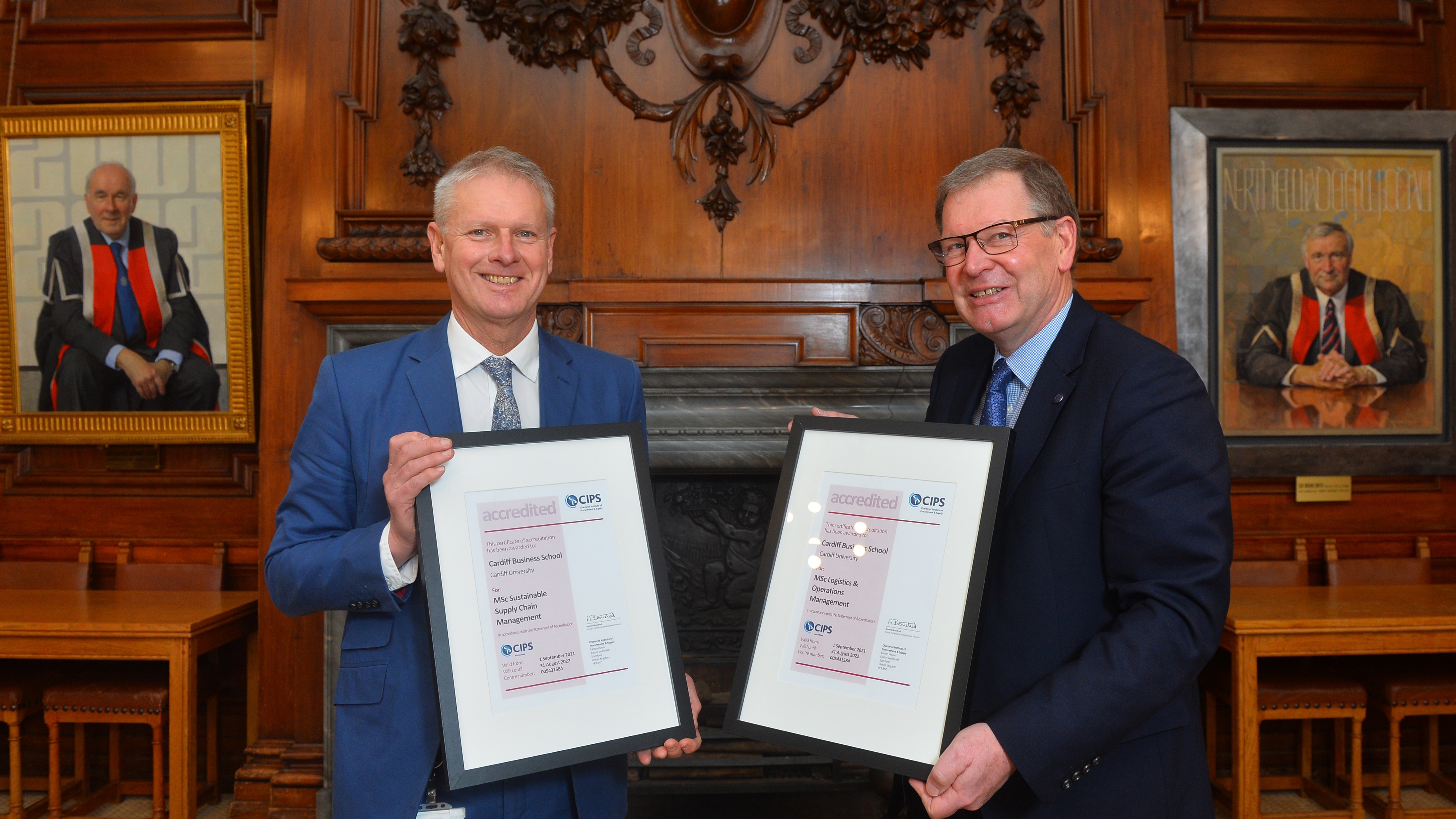 Professor Colin Riordan and Malcolm Harrison of CIPS holding a signed memorandum of understanding