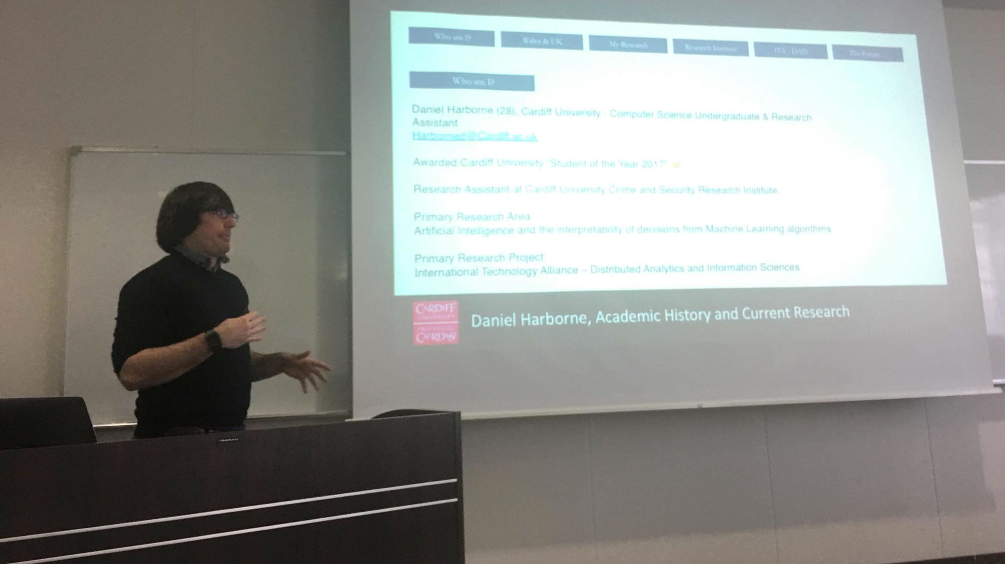 Daniel stood presenting his research in Japan.