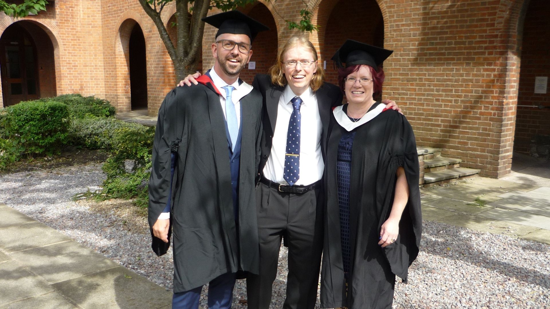 Lecturer photographed with graduates