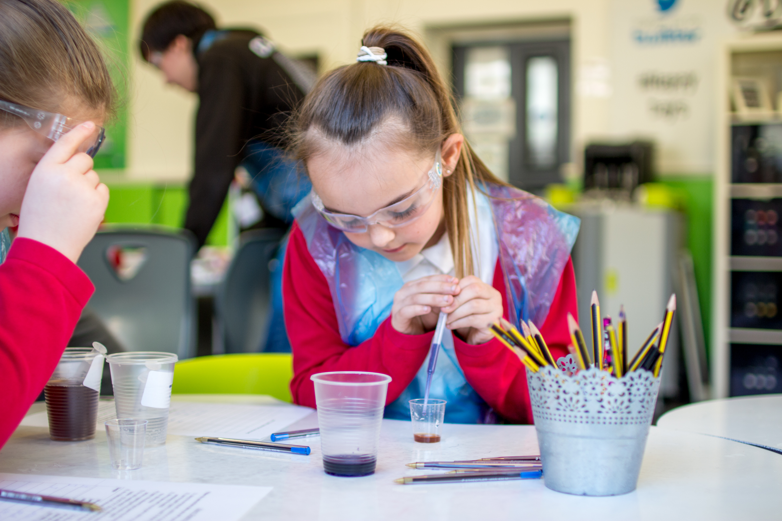 Schoolgirls conducting chemical experiment