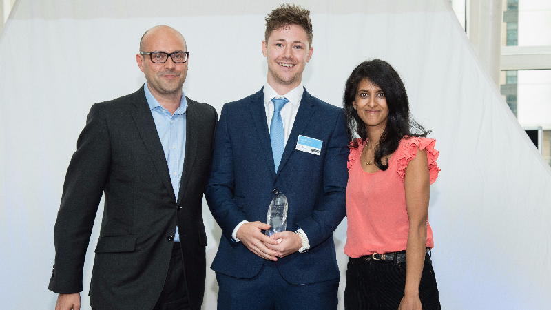 Image of two males and one female at award presentation