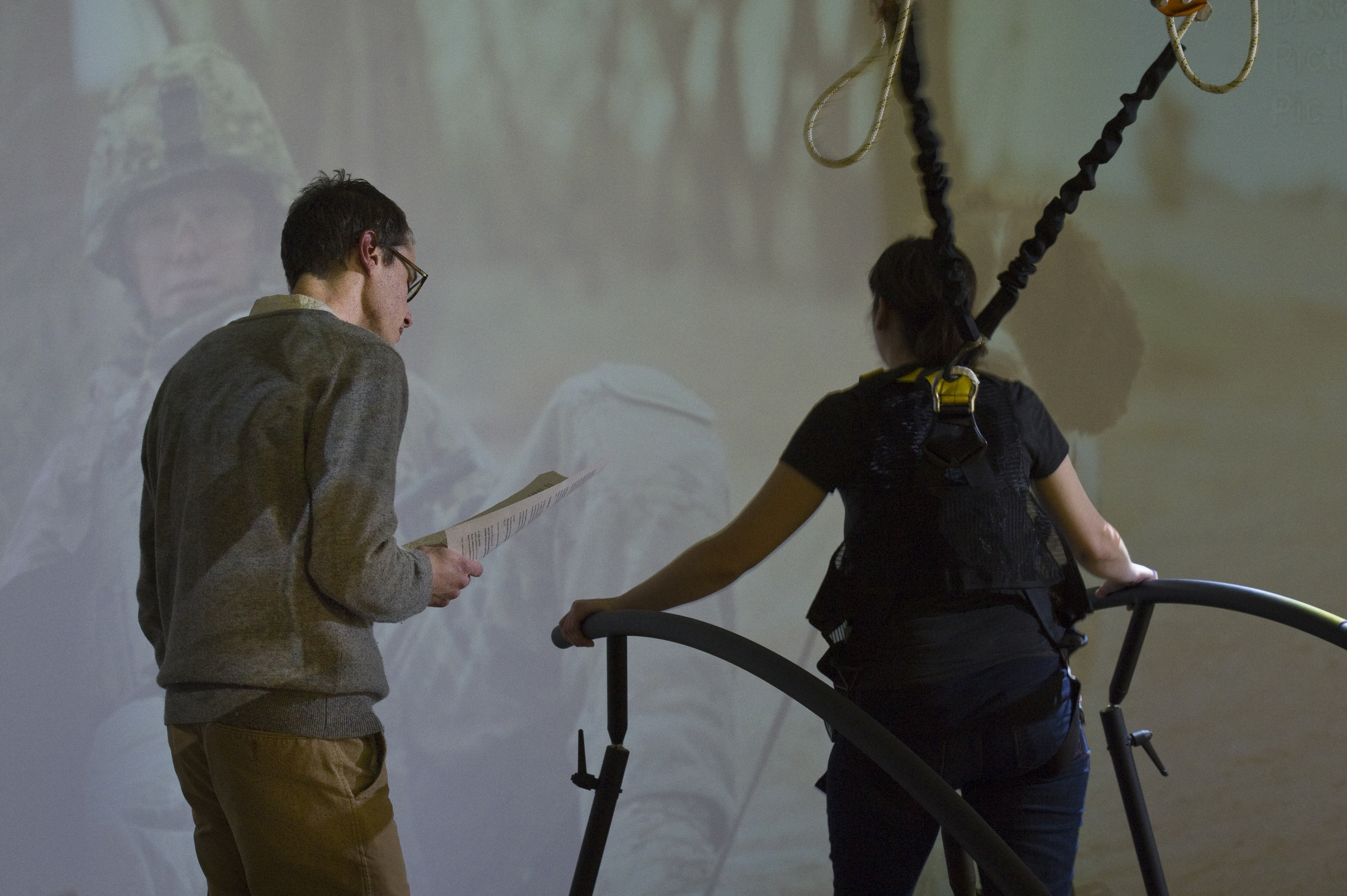 Two people operating treadmill