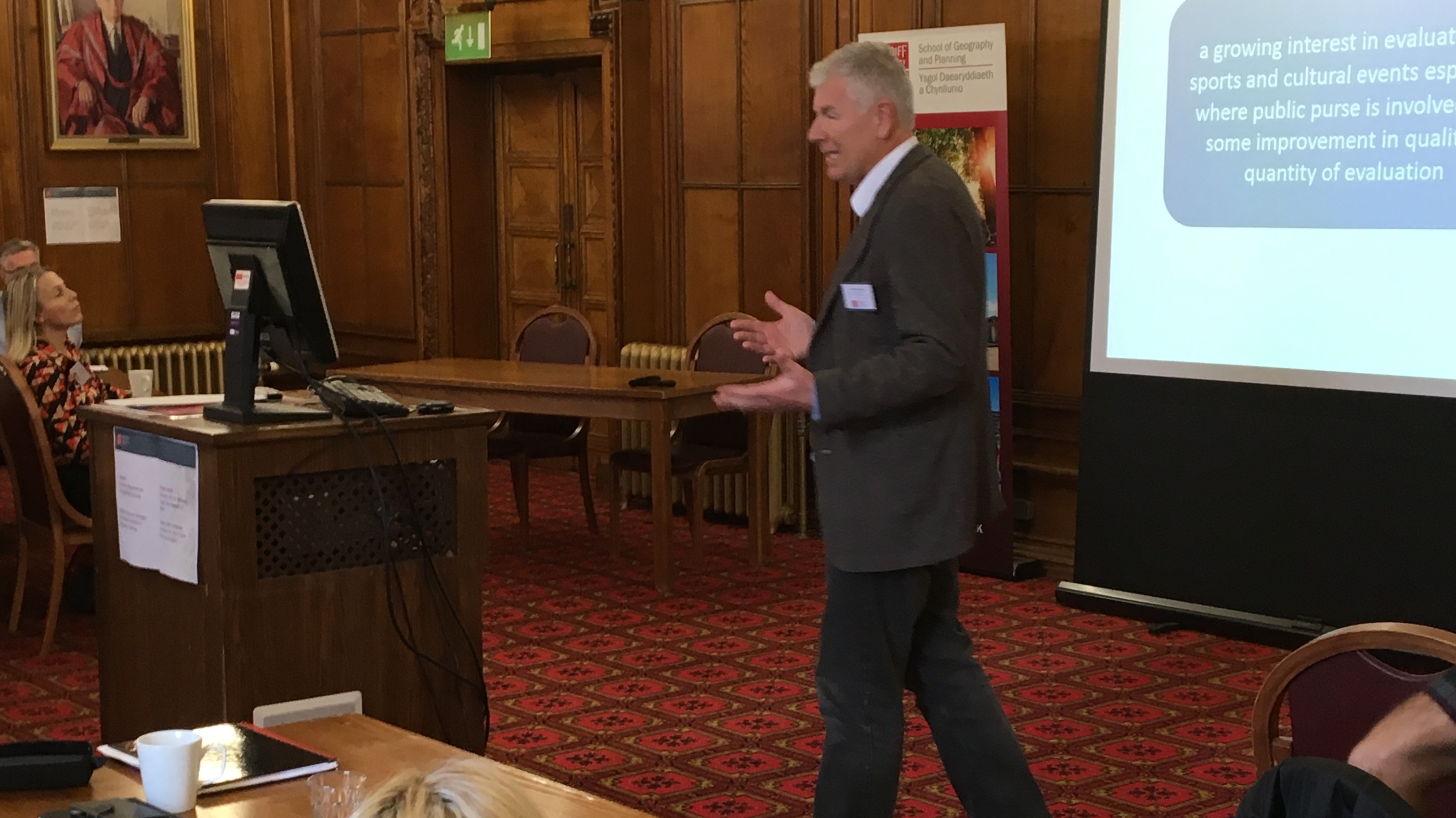 Image of male academic delivering powerpoint presentation
