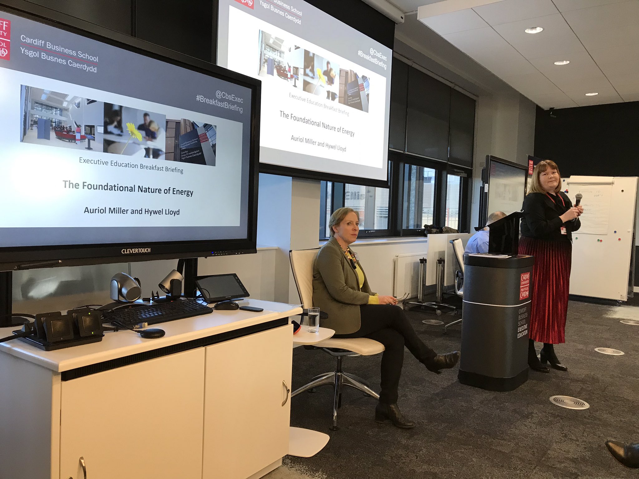 Two women at front of lecture space