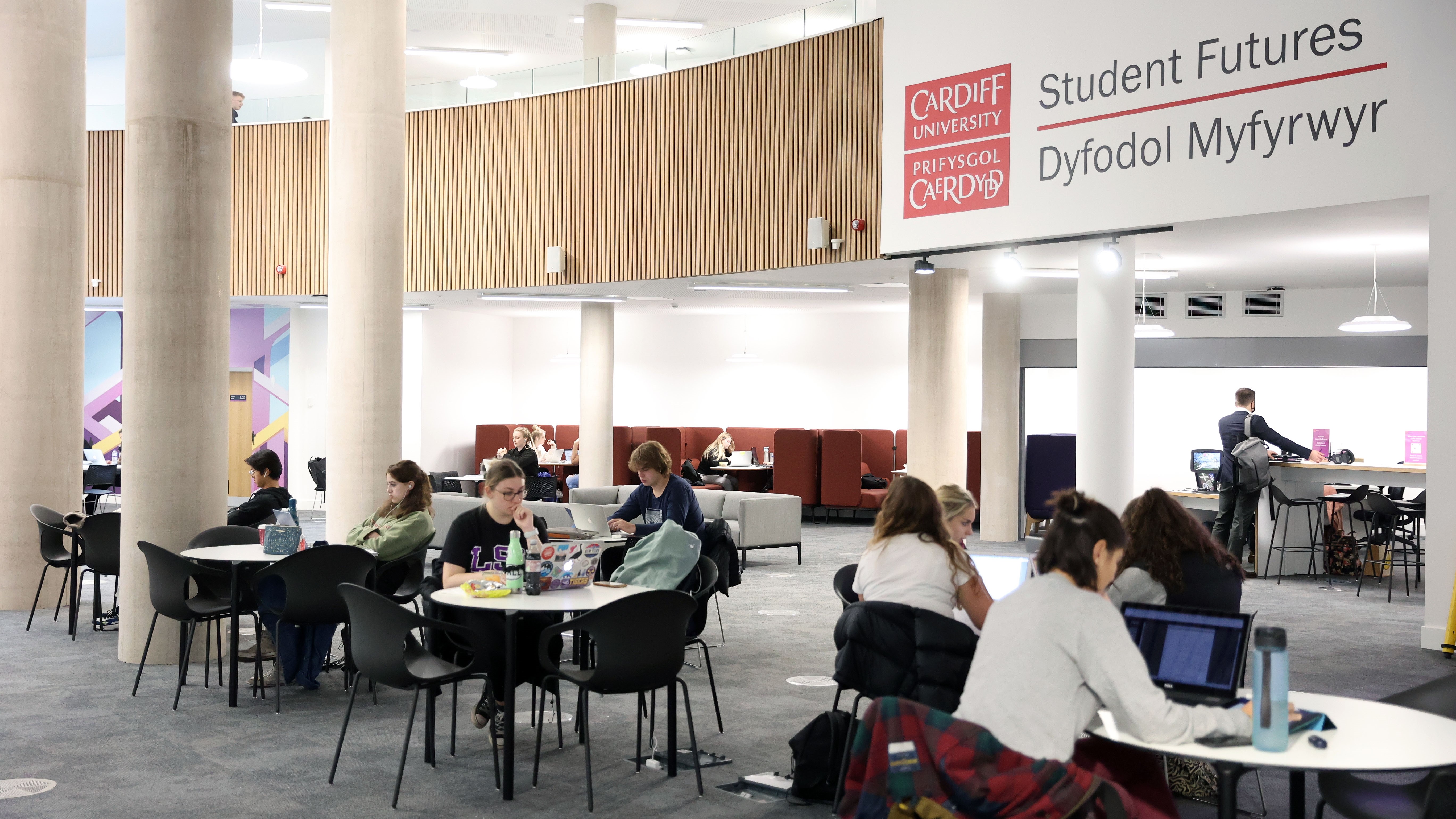 Students sitting in a light open study space.