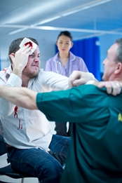 Violent man being restrained by a paramedic