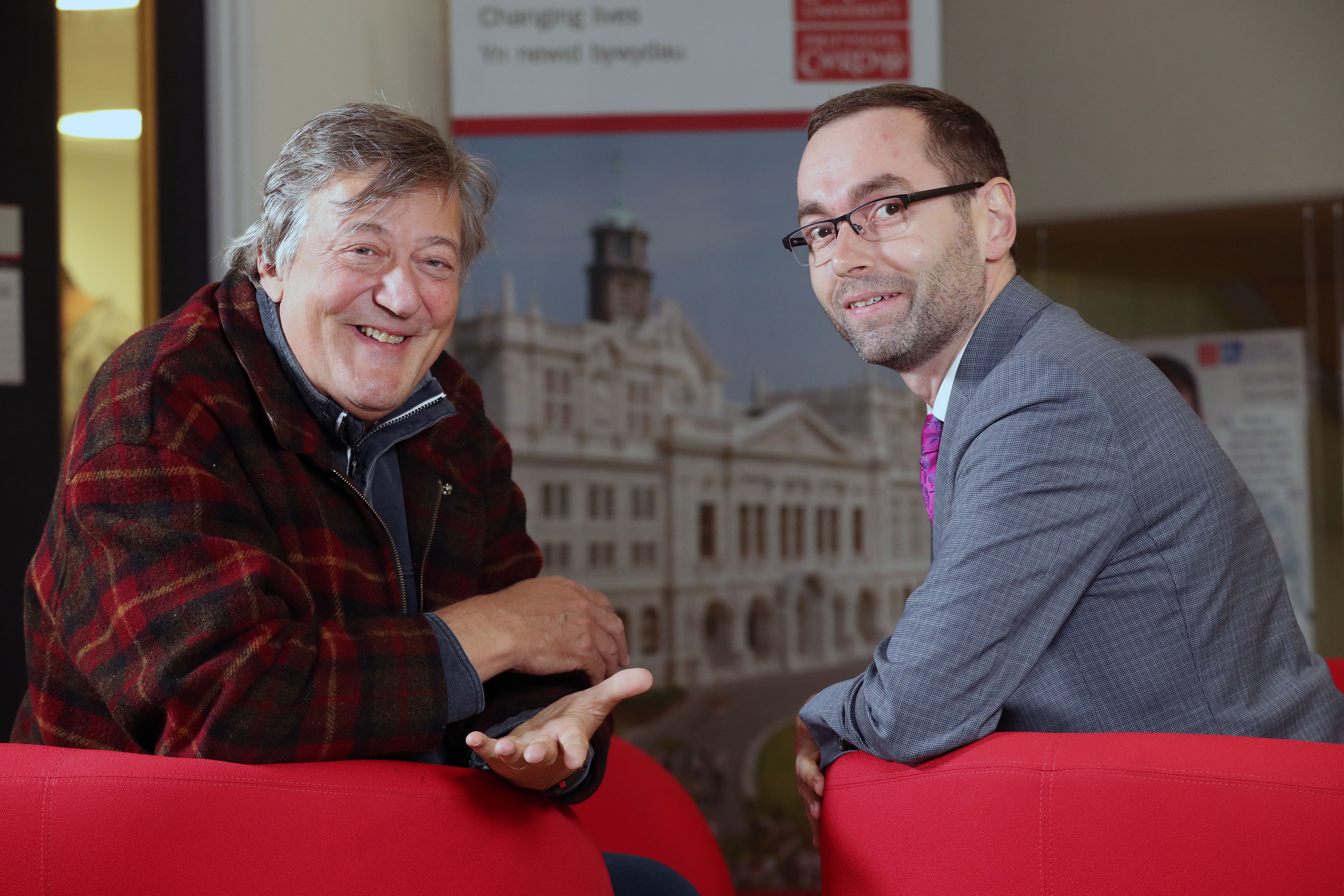 Photograph of Stephen Fry with Ben Lewis, Director of Student Support and Wellbeing