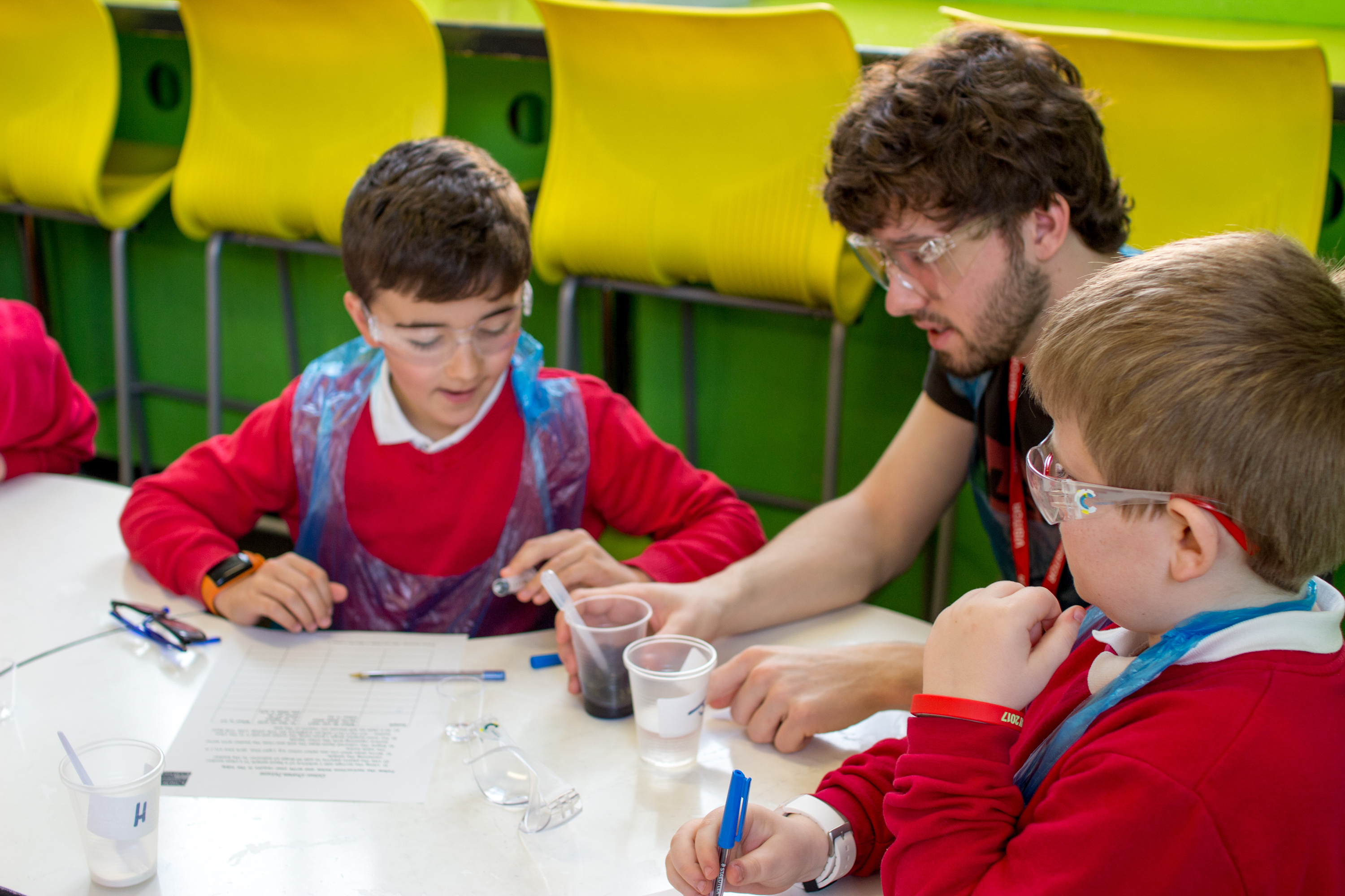 Schoolboys conducting chemical experiment