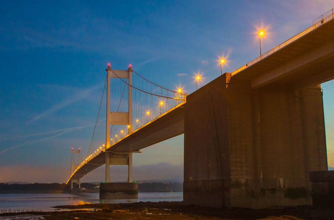 picture of Seven bridge which crosses from Wales to England. night time with orange lights spaced across the bridge's hanging metal supports