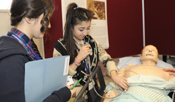 A pupil being shown how to monitor patients' vital signs